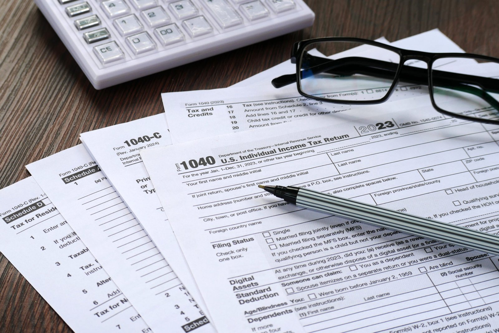 a pen and glasses on papers